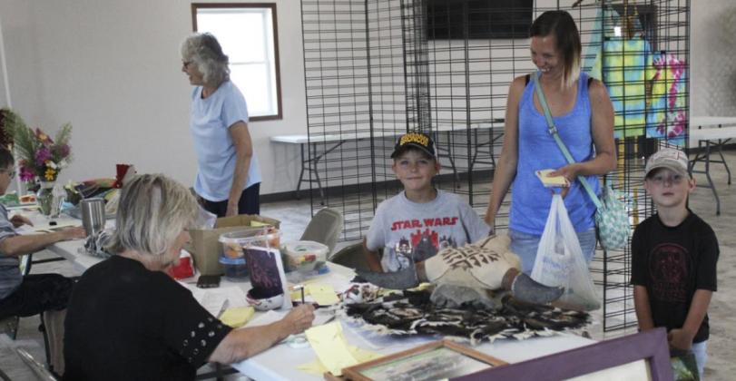 Sue Bonesteel and Val Simonson were busy helping people enter their Open Class exhibits last Thursday morning. Pictured are Sharilyn Bader and Jaxyn, Mishayla and Kayden Evans. Gerri Peterson