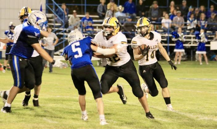 Alex Werner follows the block of Tate Kvanvig for more yardage last Thursday night in Hyannis. Carolee Brown