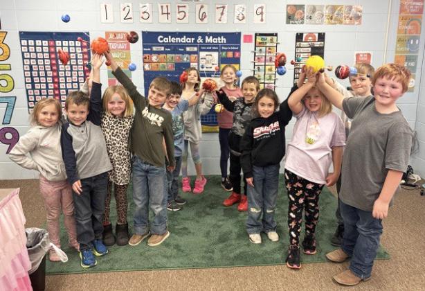 The first graders recently brought space to life in their classroom, creating solar systems! Pictured l-r: Doris Boland, Wyatt Greeley, Ryann Walz, Brogan Seeley, Wesley Simmons, Ryhme Pettit, Brystol Call, Austin Smith, Addison Mundorf, Harper Myers, Cooper Peers, Lane Brown. Jessica Myers