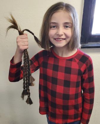 Mullen Elementary second grader Lillian Ericksen recently donated 14 inches of her hair to Wigs for Kids. Wigs are custom made with human hair and donated to children with various medical conditions. It was a little tough to make the drastic cut (little sister cried while watching big sis get the hair cut). But they discussed that it was a small inconvenience compared to what some other kids are experiencing. Awesome, Lillian! Alicia Ericksen