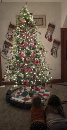 Charley and Rynley Zimmerman admiring the Polar Express train under their Christmas tree.
