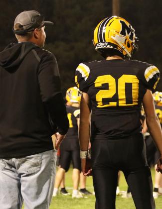 Quarterback Bo Pettit, Jr., waits for the play call from Head Coach Wade Marsh last Thursday night. Carolee Brown Photography