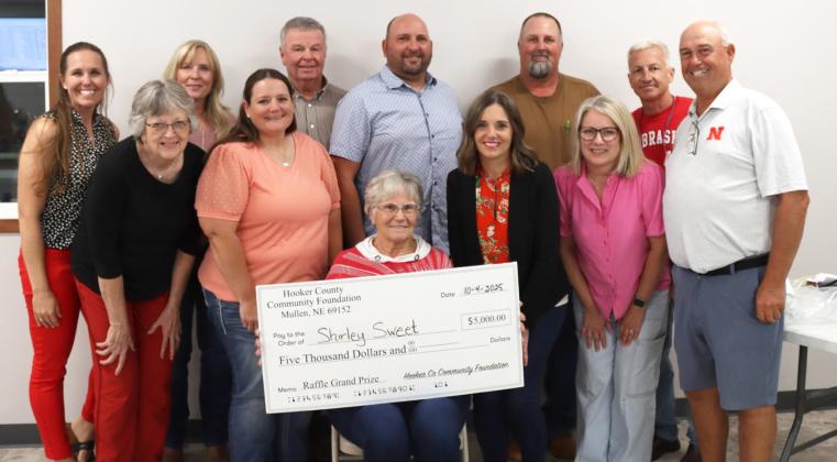 The Hooker County Community Foundation board members surround Shirley Sweet who won the top prize of $5,000 at the annual raffle fundraiser last Saturday, Oct. 4. Pictured back, l-r: Gerri Peterson, Yvonne Andrews, Kirk Jacobs, Casey Phillips, Larry Ridenour, Scott Jones. Front: Mary Lou Harding, Stacy Kraye, Kara Connealy, Barb Svoboda, Ron Boyer. Board members not present were George Vinton and Addie Lovitt. Arla Kvanvig