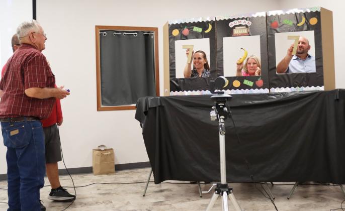 This year every 10th person out of the drawing got to play the Human Slot Machine! Here Willard Boyer tries his hand at it winning $5 on this roll for two of a kind. Shirley Osborn