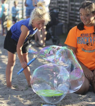 There were games for all ages of kids at the Redneck Hunger games during fair this year. A popular place for the younger ones was the dino dig, with Addison and Burke Mundorf pictured in the front above, and the bubble blast, with Mercedes Garner pictured watching Danielle Peterson’s bubble. Gerri Peterson