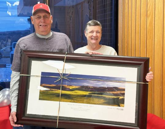 Sand Hills Golf Club honored two of their long-time employees who retired this year with an open house on Sunday, Nov. 30. Carol Wright, pictured with her husband John G., was the Laundry Supervisor since Aug. 3, 2001. Clint Svoboda