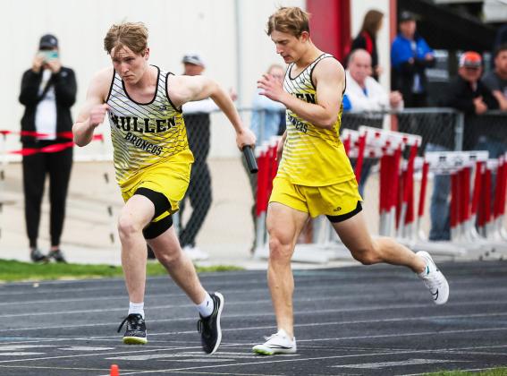 Brandon Hardin gets the baton from Alex Werner in the 4x4 relay at the Best of the Midwest meet last Tuesday.