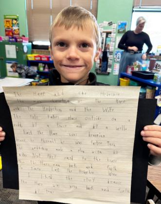 The 2nd grade students used the writing process to write a narrative book report on the story, “The Hare and the Hedgehog”. Pictured are Eve Ericksen and Trent Cox.