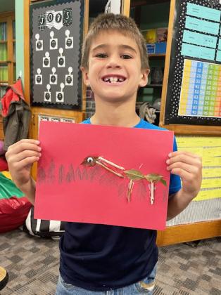 Danielle Peterson and Tru Mundorf are pictured with their leaf animals. The 2nd graders went on a leaf hunt to find leaves to make animals.