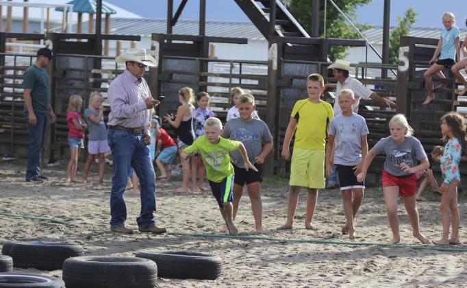 Weston Ourada and Ava Walz start the Obstacle Course Monster Slip &amp;amp; Slide relay race for their teams. Gerri Peterson