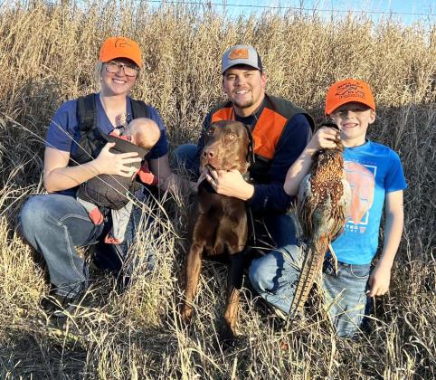 Erica Meyer said her family enjoys every minute of hunting and fishing as a family. L-r: Erica, Riggs, Grant, dog Tank and Cooper Meyer. It was 2-month-old Riggs’ first pheasant hunt.
