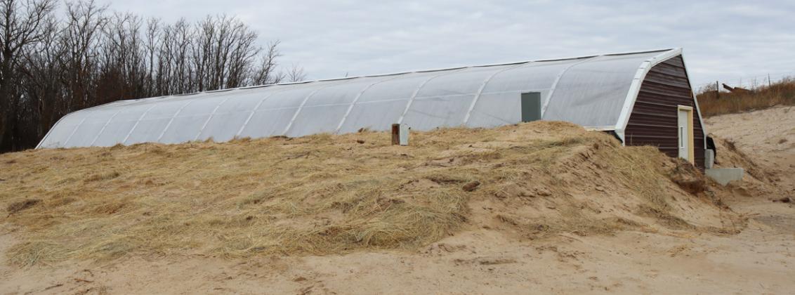 The greenhouse is built into a hill north of the bus barn.