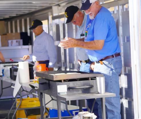 American Legion members Don Younkin, John Simonson and Chuck Anders (l-r) serve breakfast at the fly-in.