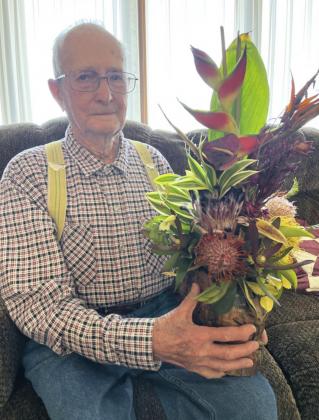 Frank Harding holds a Hawaiian bouquet that was shipped to him for his 100th birthday from his niece Rita Fischer, who was wintering in Hawaii. Frank tried encouraging the Tribune to be done running his photo by saying, “I’ve had my photo in the paper enough over the years.” But the Tribune made no promises! Gerri Peterson