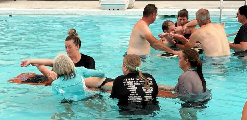 After a thunderstorm cut the pool barbecue short, the lifeguards and EMTs were eventually able to get into the pool with trainer Mike Bailey last Monday evening, July 28. Sarah Hardin