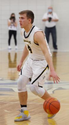 Brendon Walker brings the ball down the court. Barb McIntosh