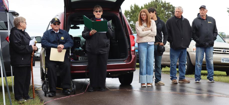 It was a cool and damp Memorial Day weekend in Mullen, but the annual program was still held Monday morning at the Cedarview Cemetery. Pictured reading above is American Legion Auxiliary #109 president Eva Crawford.