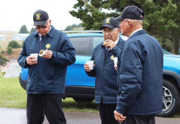 Part of the American Legion Post #109 firing squad enjoys a warm cup of coffee and cookies at the canteen following the program, l-r: John Simonson, Don Younkin and George Jenkins.