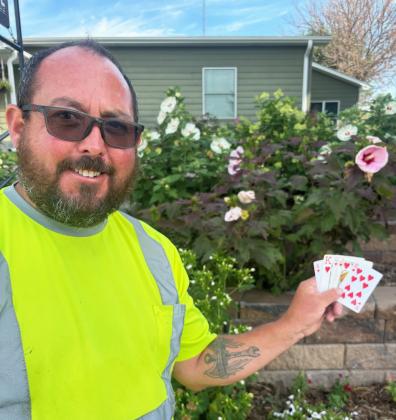 Tony Corbin pictured with his winning royal flush poker hand. Gerri Peterson