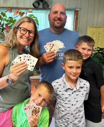 The Phillips family pictured with Casey’s third place four of a kind poker hand - Heather, Casey, Johnny, Tate and Cooper.