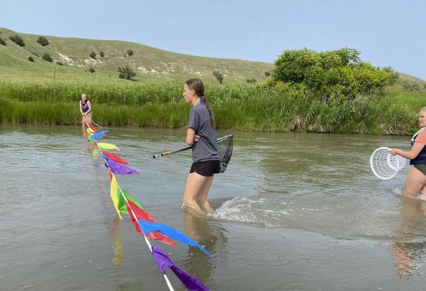 L-r: Ava Walz, Harper Andersen and Maci Walz prepare to catch the rubber ducks as they come across the finish line last month during the FCCLA Duck Race. Kelli Walz