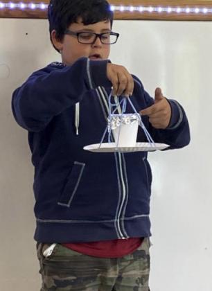 Second graders build bird feeders