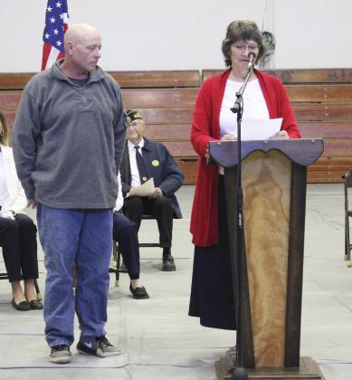 American Legion Auxiliary president Eva Crawford recognizes Chris Jensen during the Veterans Day program.