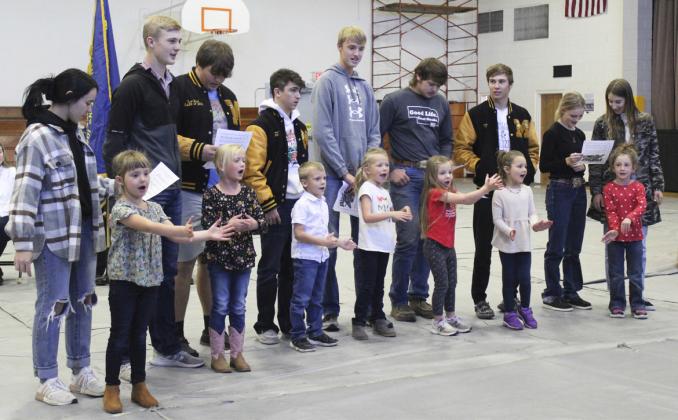 The MHS seniors performing a song with the kindergartners at the Veterans Day program has become a Mullen Public Schools tradition. The group sang “This Land is Your Land.” Seniors pictured l-r: Bella Brown, Clayton Moore, Isaac Welch, Jeffery Forsen, Alex Moore, Deacon DeNaeyer, Eli Paxton, Ashton Werth, Whitney Jennings. Kindergartners, l-r: Aislynn Connealy, Danielle Peterson, Trent Cox, Fallon Lee, Eve Ericksen, Ellie Licking, Dailie Dent.