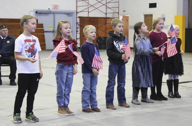 The first graders sang “You’re a Grand Old Flag.” Part of the class is pictured l-r: Eli Barnes, Sadie Hoyt, Killian Kearns, Grady Phipps, Zandra Hebbert, Tatum Deibler, Daryl Deibler.