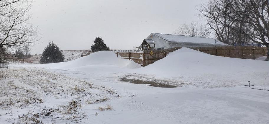 Drifts up against a 6 foot tall fence at Jim and Crystal Hessin’s in Mullen.
