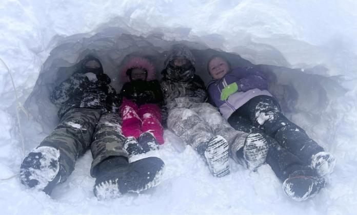 The drift behind the Tribune office was perfect for building a snow cave! Pictured l-r: Hayden Deibler, Danielle Peterson, Teal Peterson, Tatum Deibler.