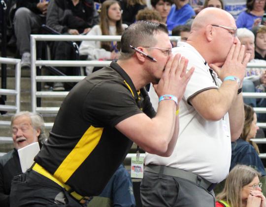 MHS wrestling coaches Bo Pettit (left) and Russ Monette during Gracey’s semifinal match where he defeated Maddox Jones of Summer-Eddyville-Miller, who he had lost to earlier this season.