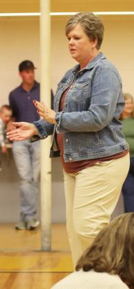K-8 music teacher Mary Jo Walker helps keep the beat during the 4th and 5th grades’ Tinikling Stick Dance.