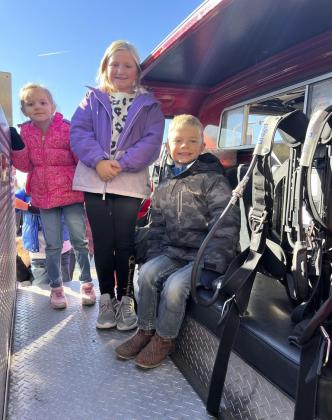 Anna Hessin, Tatum Deibler and Killian Kearns checking out the fire truck.