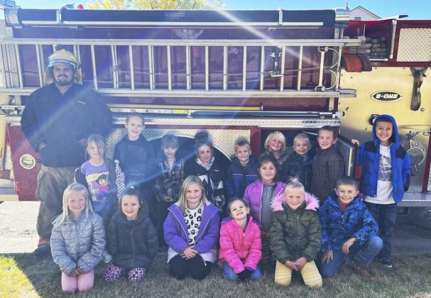 The Mullen kindergarten and first grade are pictured with firefighter Chris Wurm, back l-r: Eve Ericksen, Eli Barnes, Aislynn Connealy, Dailie Dent, Trent Cox, Daryl Deibler, Killian Kearns, Holt Morrison, Marcus Lattin. Front: Fallon Lee, Ellie Licking, Tatum Deibler, Anna Hessin, Zandra Hebbert, Danielle Peterson, Grady Phipps. courtesy photos