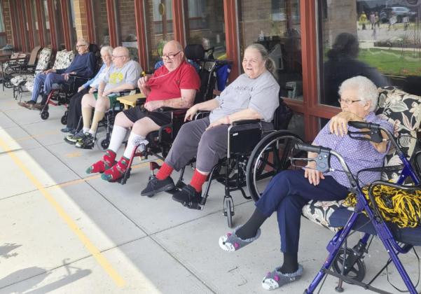 Several residents enjoying the Homecoming parade. We thank the MHS facility and students for coming over. We enjoyed it.
