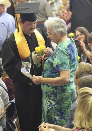 Tel Kvanvig delivers a yellow rose to his grandma Judy Ridenour. Gerri Peterson