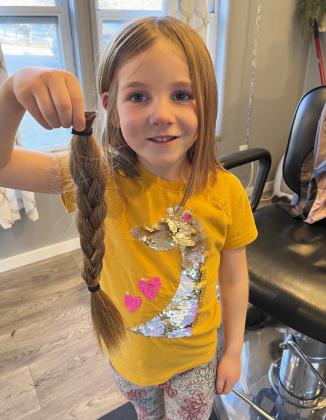 Eve Ericksen decided that since her big sister did it, she wasn’t scared to “give a wig.” Eve, a kindergartner at Mullen Elementary, donated 14 inches to Wigs for Kids. Marc Ericksen