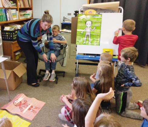 Dr. Alicia Ericksen tests Luke Cox’s reflexes. Donalee Barner