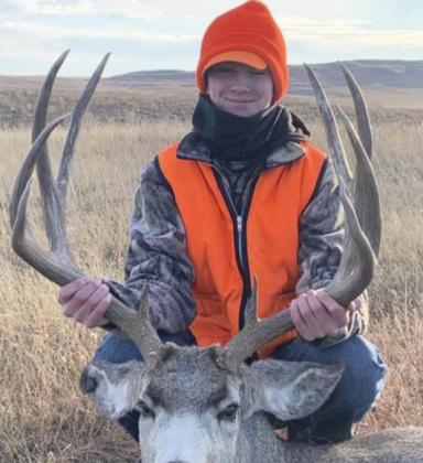 Cayden Hampton with his rifle season buck