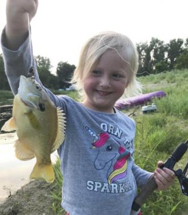 4-year-old Danielle Peterson shows off a summer catch