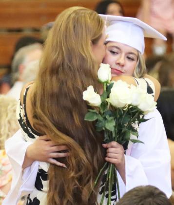 Keragan Welch gives her mom, Marcia Welch, a hug during the flower presentation.