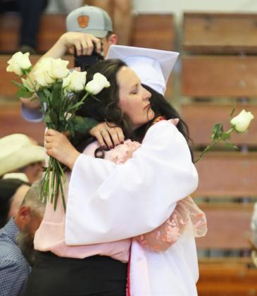 Fayth Brown gives her mom, Carolee Brown, a hug during the flower presentation.