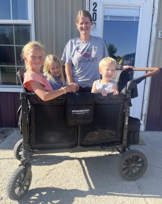 Jessica Polt and her Wonderfold Wagon with Danielle Peterson and Aurora and Arthur Polt riding along. Gerri Peterson