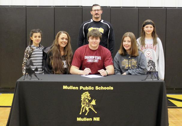 MHS senior Isaac Welch signed his letter of intent to wrestle for Chadron State College last Friday, April 21. He is pictured with MHS wrestling coach Bo Pettit and his mom and sisters, l-r: Mia Roman, Marci Roman, Keragan Welch and Langston Pohlmeier-Fajardo. Gerri Peterson