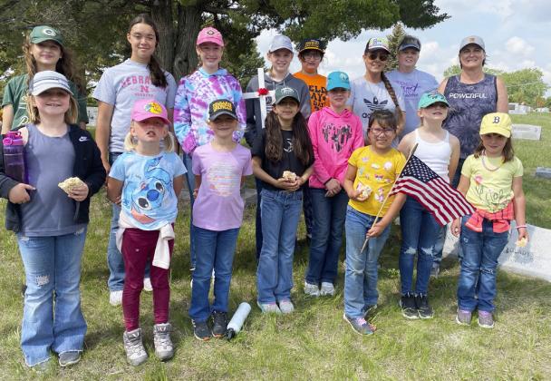 Girl Scouts and adult helpers who put crosses and flags on the veterans’ graves at the Cedarview Cemetery last Thursday are pictured back, l-r: Langston Pohlmeier-Fajardo, Mercedes Garner, Taylor Moore, Chloe Newman, Pandora Gray, Marci Roman, Mary Jo Walker, Nikki Gracey. Front: Tatum Deibler, Daryl Deibler, Danielle Peterson, Mia Roman, Logan Moore, Natalee Walker, Elle Gracey, Aislynn Connealy. Sooky Marks