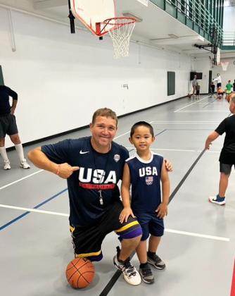 Jeff Nichols and a young kiddo sport their team USA jerseys at basketball camp. courtesy photo
