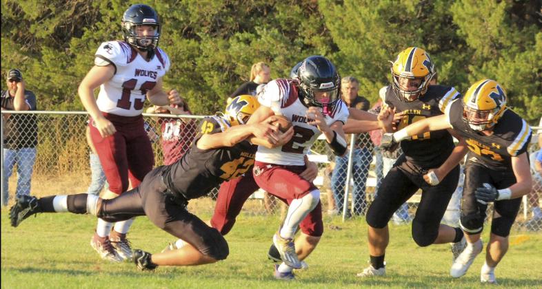 Tate Kvanvig pulls down Twin Loup’s quarterback last Friday night with James Kessler and Ethan Hardin on their way to assist. Carolee Brown
