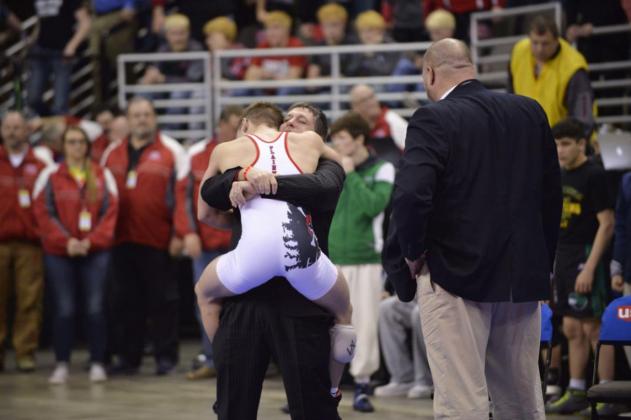 Plainview wrestling coach Dean Boyer hugs Christian Miller after the senior capped an undefeated season by winning the Class D 138-pound championship at the State Wrestling Tournament in Omaha in this February 2017 photo. Darin Epperly/Daily News