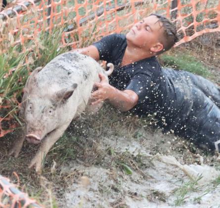 Carson Hegland dives for a pig.